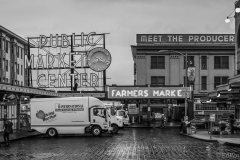 pikes place market delivery trucks in the rain black and white